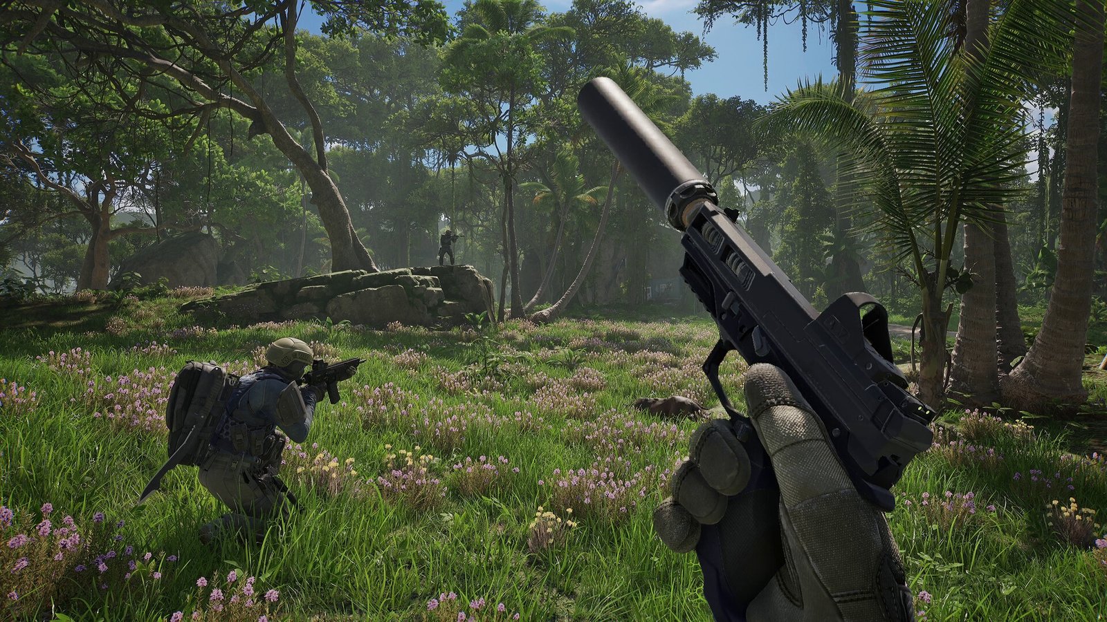 A first-person view of a player holding a suppressed handgun in a lush, flower-filled tropical jungle, with another player crouching and aiming a rifle in the middle ground, and the green glowing logo "PUBG BLACK BUDGET" overlaid on the scene.